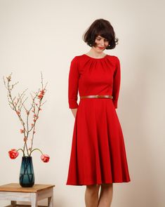 "Simple elegance in red! A beautiful spring dress is made of thicker knit fabric with a wide skirt and 7/8 sleeves. Especially nice is the pleated neckline. The bodice is form-fitting and the skirt swings at each movement of the loose-fitting form. (The belt is not is included) Size / Weight / Length: variable from 95-110 cm (100 cm in the photo) \"Lucy\" is available in sizes 36-42. materials Viscose, Spandex Care instructions: Wash at 30 degrees, iron hot from left Production Handmade in berli Red 3/4 Sleeve Dress For Fall, Red 3/4 Sleeve Midi Dress For Fall, Red Midi Dress With 3/4 Sleeves For Fall, Round Skirt, Beautiful Spring Dresses, Wide Skirt, Pleated Neckline, Red A, Simple Elegance