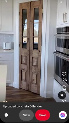 an open door in a kitchen next to a stove top oven and microwave on the wall