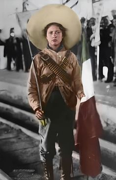 a man wearing a sombrero and holding a mexican flag