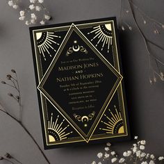 a black and gold wedding card with the words madison jones and nathan hopkins on it