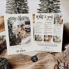 two christmas cards sitting on top of a table next to pine cones and fir trees