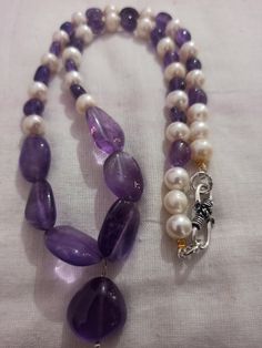 Amethyst Necklace Smooth AAA Tumble Beads With Center Tumble Gemstone 20 inch Necklace Stone : Natural Amethyst Fresh Water Pearl Shape :- Tumble Size :- 7x7-14x18mm 1. Weight :- 237 carat With Amethyst Tumble, 20 INCH Necklace Polish :- Handmade Purity :- 100% Natural Gemstone color - white blue It is known as the 'love stone' as the message it emits is the strong vibration of unconditional love, joy, warmth and healing. As quartz crystals are profound amplifiers of energy, it may help to kindl Amethyst Tumbled, 20 Inch Necklace, Necklace Stone, Fresh Water Pearl, Quartz Crystals, Amethyst Necklace, Gemstone Colors, Stone Necklace, Quartz Crystal