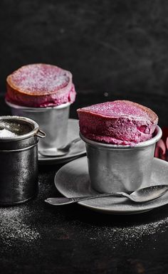 two desserts sitting on top of silver dishes