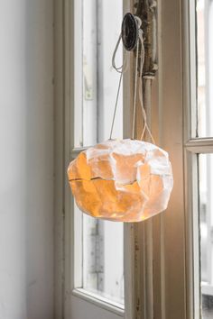 a light fixture hanging from the side of a window