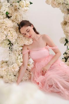 Step into a fairytale in the enchanting Aurora Dress. Crafted from the softest pink tulle, this gown feels like floating on a cloud. Cascading layers of draperies create a gorgeous, flowing silhouette that moves gracefully with every step. Lined with duchess satin, this piece is adorned with dreamy ribbon trims. Delicate off-shoulder sleeves and intricate corset lacing complete the romantic look. Handmade with love for the modern princess, the Aurora Dress is designed to be cherished and treasur Cascading Layers, Corset Lacing, Aurora Dress, Modern Princess, Duchess Satin, Corset Lace, The Aurora, Romantic Look, Pink Tulle