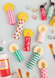 various craft supplies laid out on top of a white surface, including glue and paper