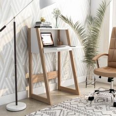 a desk with a laptop on it next to a chair