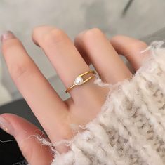 🌸 Introducing Our Fashion Buckle Ring! 🌸 Add a touch of Fashion and charm to your style with our delightful Minimalistic geometrical Pearl Ring! Crafted with love and care, this adorable accessory is a must-have for any fashionista looking to elevate their style game. ✨ Colors: ✨ Gold 🌟 Material: 🌟 Made from high-quality Titanium Steel, ensuring durability and a brilliant shine that lasts. Artificial Pearl 🎀 Adjustable Size: 🎀 Ring Sizes  06-09 💖 Key Features: 💖 Adorable geometrical desi Trendy Gold Pearl Ring Gift, Simple Pearl Ring As A Gift, Minimalist Open Pearl Ring For Gift, Minimalist Metal Rings As Gifts, Minimalist Adjustable Pearl Ring As Gift, Minimalist Adjustable Pearl Ring For Gift, Open Pearl Ring Gift, White Minimalist Midi Rings, Trendy Simple Design Midi Rings As Gift