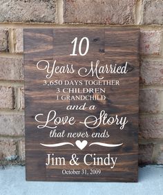 a wooden sign with the words 30 years married and children, love story that never ends