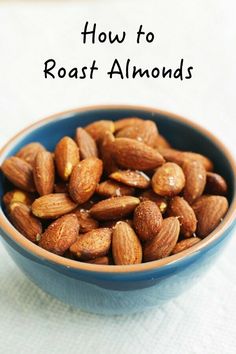 a blue bowl filled with almonds on top of a table