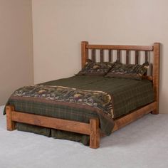 a bed sitting in the corner of a room with a wooden frame and headboard