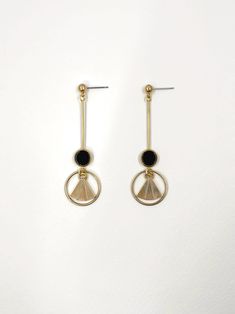 These earrings are inspired by the geometric patterns characteristic of the Art Deco era. Polished, semi precious black agate stone feature at the centre, contrasting with the surrounding warm, golden brass.  The bold lines and symmetry of the design are simultaneously classic and contemporary.  Held by a solid brass stud with stainless steel earring post.  Approximate measurements- 6.75cms long 2cms wide  ✨All Set Theory jewellery comes with care instructions and a polishing pad to keep your je Luxury Art Deco Brass Jewelry, Luxury Gold Art Deco Earrings, Luxury Brass Art Deco Jewelry, Black 14k Gold Art Deco Jewelry, Contemporary Precious Stone Earrings, Handmade Brass Art Deco Earrings, Black Brass Drop Earrings, Art Deco Dangle Brass Earrings, Luxury Black Art Deco Earrings