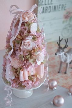 there is a small tree made out of flowers and pearls