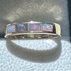 An Australian Inlay Opal Ring In 14k Yellow Gold With Four Inlay Opals Displaying Very Bright Multi Colors. Size: 7 In Excellent Pre-Owned Condition! Opal Ring, Australian Opal, Yellow Gold Ring, Multi Stone, Opal Rings, Yellow Gold Rings, Gold Ring, Gold Rings, Opal