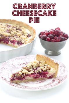 cranberry cheesecake pie on a plate next to a bowl of cherries