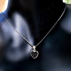 Hearts symbolize love and commitment, giving this delicate, brightly polished pendant necklace added meaning along with pure style. A black cubic zirconia inlay is set in the middle framed by a heart-shaped halo beautifully centered on a shiny black cable chain made of sterling silver. This lovely necklace is made of oxidized silver and the heart has 2 sides, one with black zircons and one with white zircons, so you basically have 2 necklaces for the price of one. DETAILS - 925 Sterling Silver Black Heart-shaped Jewelry For Anniversary, Black Necklaces For Anniversary On Valentine's Day, Black Necklace For Anniversary On Valentine's Day, Valentine's Day Black Necklace For Anniversary, Black Enamel Heart Pendant Jewelry, Black Jewelry For Valentine's Day Gift, Black Heart Charm Pendant Jewelry, Black Double Heart Jewelry For Anniversary, Black Cubic Zirconia Pendant Jewelry