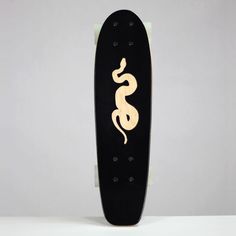 a skateboard with an image of a snake painted on it's back end