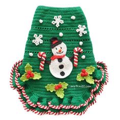 a green crocheted christmas bag with a snowman on it and candy canes