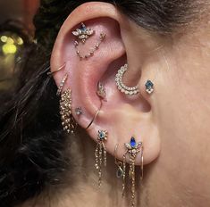 a close up of a person with ear piercings on their ears and behind the ear