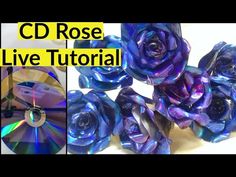 the cd rose is being made with blue and purple glass flowers on it's side