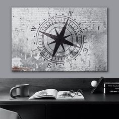 a black and white photo of a desk with a compass on it