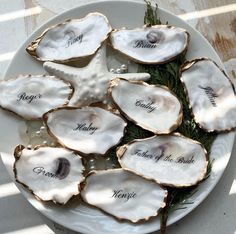 oysters with names on them sitting on a plate