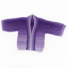 a purple sweater hanging on a white wall