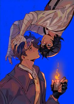 two people kissing each other with one holding a lit candle in his hand while the other holds