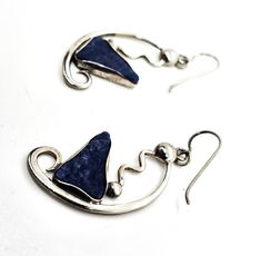 Abstract Modernist Blue Sodalite gemstone handcrafted vintage sterling silver drop earrings. Good vintage condition with little to no signs of normal vintage wear. Stamped Sterling on the back of each earring. Blue sodalite polished slab set in unique sterling silver setting with handcrafted abstract setting. Hook fastening. Acid tests positive for sterling silver. Earrings measure 2 inches tall and 7/8ths of an inch wide. Spring Hill Florida, Blue Sodalite, Sterling Silver Drop Earrings, Silver Drop Earrings, Vintage Wear, Vintage Sterling Silver, Silver Earrings, Drop Earrings, Gemstones