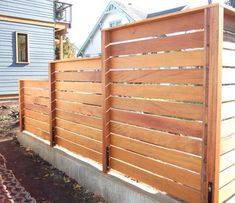 a wooden fence in front of a house