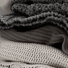 a pile of sweaters stacked on top of each other