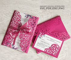 a pink and white wedding card with a bow on the front, and an intricate laser cut