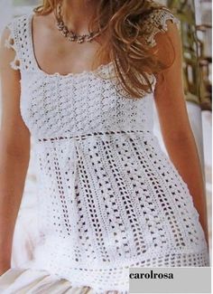 a woman is wearing a white crochet top