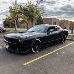 a black sports car parked in a parking lot