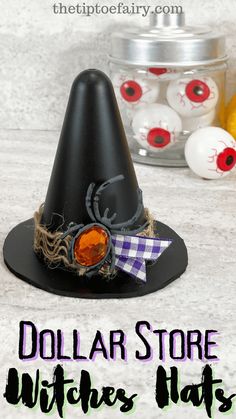 a black witches hat sitting on top of a table next to an orange and white ball