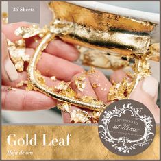 a gold leaf brochure is being held by someone's hand