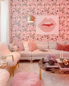 the living room is decorated in pink and gold with floral wallpaper on the walls