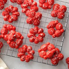 red cookies with white sprinkles on a cooling rack