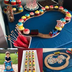 there is a train cake and cupcakes on display at this birthday party,