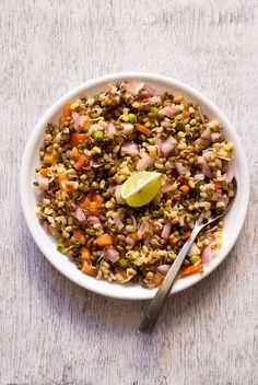 a white bowl filled with food on top of a wooden table