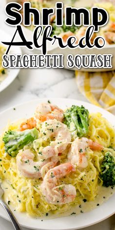 shrimp alfredo with broccoli and noodles on a white plate next to a fork