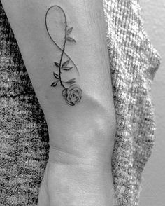 a woman's arm with a tattoo on it and a rose in the middle