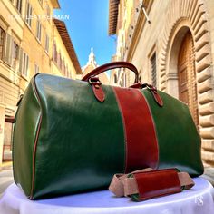 This Italian leather travel bag is expertly handcrafted in Florence, Italy, using the finest genuine leather. Designed for men seeking premium quality, luxury, and modern Italian fashion. Elevate your style with this exquisite accessory. . Size: Height: 30 cm (11.81 inches) Depth: 55 cm (21.65 inches) Width: 25 cm (9.84 inches) . The story of this travel bag: In the heart of Italy, where the rich legacy of craftsmanship thrives, there existed a renowned workshop dedicated to creating exquisite travel accessories. Among their coveted collection were the handmade duffle bags, carefully crafted to cater to the needs of discerning travelers seeking both style and functionality. These duffle bags, designed specifically as men's travel gear, embodied the essence of Italian travel bags. The artis High-end Leather Travel Bag For Everyday Use, High-end Leather Travel Bag, High-end Leather Rectangular Travel Bag, Luxury Green Bag With Smooth Grain, High-end Rectangular Leather Travel Bag, Luxury Green Travel Bag For Everyday Use, Luxury Green Travel Bag For Daily Use, Green Leather Duffle Bag With Luggage Sleeve, Designer Leather Rectangular Weekender Bag