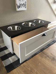 the dog bowl is built into the bottom of this cabinet