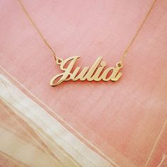 "Wear your name with pride with this stunning solid 14K gold necklace! Order any name in this pretty script typeface up to 8 letters. The biggest difference between our necklace and competitors is that ours is REAL gold. It is NOT gold filled OR gold plated, it is SOLID 14k gold - both the nameplate AND the chain! All of our gold is hand stamped for authenticity so you know that you are getting a trusted jewelry product. Name hangs picture style on a solid gold box chain (1 gram of gold) in 14\" Classic Yellow Gold Name Necklace, Classic Customizable Yellow Gold Necklaces, Customizable Classic Yellow Gold Necklaces, Classic Customizable Yellow Gold Necklace, Classic 14k Gold Custom Necklace For Personalized Gift, Custom Classic Necklace For Anniversary, Customized Classic 14k Gold Jewelry, Classic Personalized Name Necklace, Valentine's Day Elegant Custom Name Necklace