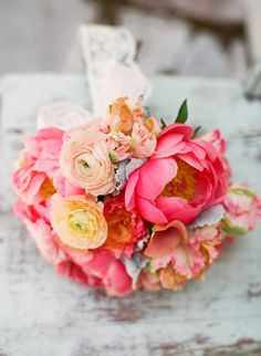 a bouquet of flowers sitting on top of a wooden table