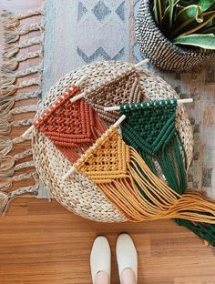 a person standing in front of a basket with different colored tassels on it