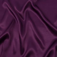 Who could deny the elegance of this Mood Exclusive Elliana Plum Sustainable Viscose Fluid Satin? The durability and smooth glide of this satin make it a pleasure to sew with, and every project is a breeze with its soft, slick texture and flexible drape. Without stretch, create fabulous sewing projects for any occasion, including blouses with bell sleeves, dresses, and maxi skirts with ruffle accents. As this material is opaque, a lining can be used for structure if desired.

MoodEarth Verified: This fabric contains EcoVero Viscose, a sustainable viscose with responsible wood sourcing, up to 50% lower water impact, and up to 50% lower CO2 emissions. For more information on Mood's sustainability initiatives, check out MoodEarth here. Purple Silk Background, Purple Silk Wedding Fabric, Violet Fabric, Dark Purple Fabric, Satin Fabric Purple, Mood Sewciety, Mood Designer Fabrics, Designer Lingerie, Mood Fabrics