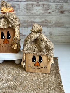 two wooden pumpkins with faces painted on them