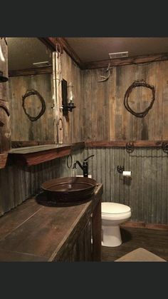 a rustic bathroom with wooden walls and flooring